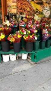 buckets of flowers at an outdoor market